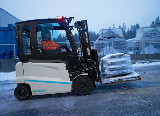A worker moving a pallet up an incline using a MX2 unicarriers forklift