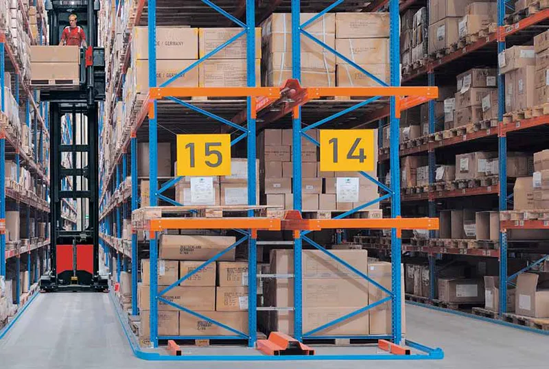 An Operator Using a Linde VNA Turret Truck Inside of a Warehouse 