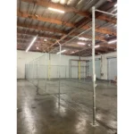 Thumbnail of http://Chain%20link%20fencing%20inside%20of%20an%20empty%20warehouse