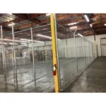 Thumbnail of http://Chain%20link%20fencing%20inside%20of%20an%20empty%20warehouse