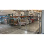 Thumbnail of http://Chain%20link%20fencing%20featuring%20a%20sliding%20gate%20inside%20of%20a%20warehouse