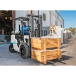 Thumbnail of http://A%20worker%20moving%20a%20crate%20outside%20using%20a%20unicarriers%20pf%20series%20forklift